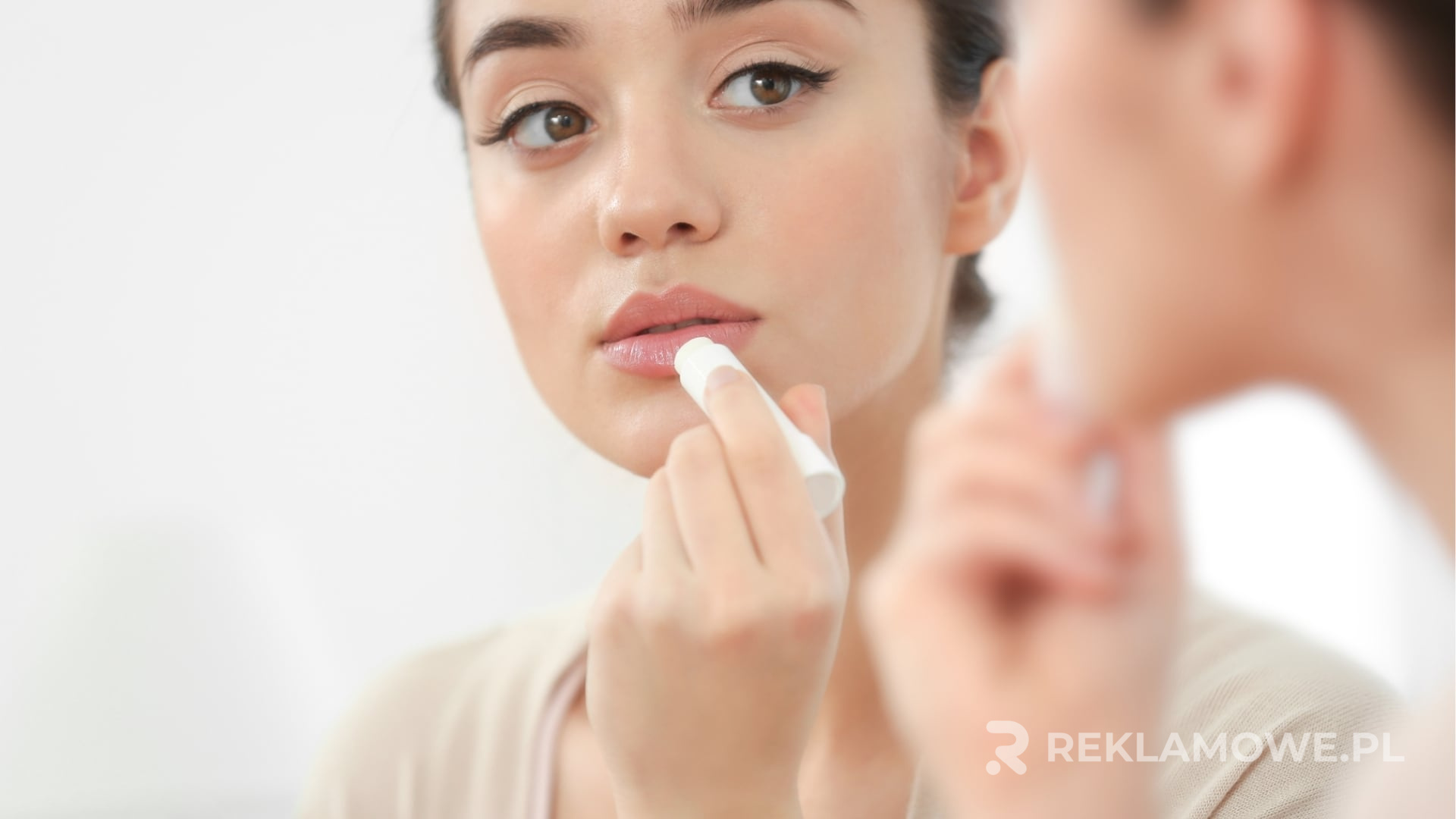 Pomadki reklamowe jako efektywne narzędzie marketingowe Pomadka reklamowa na tle różnych gadżetów promocyjnych